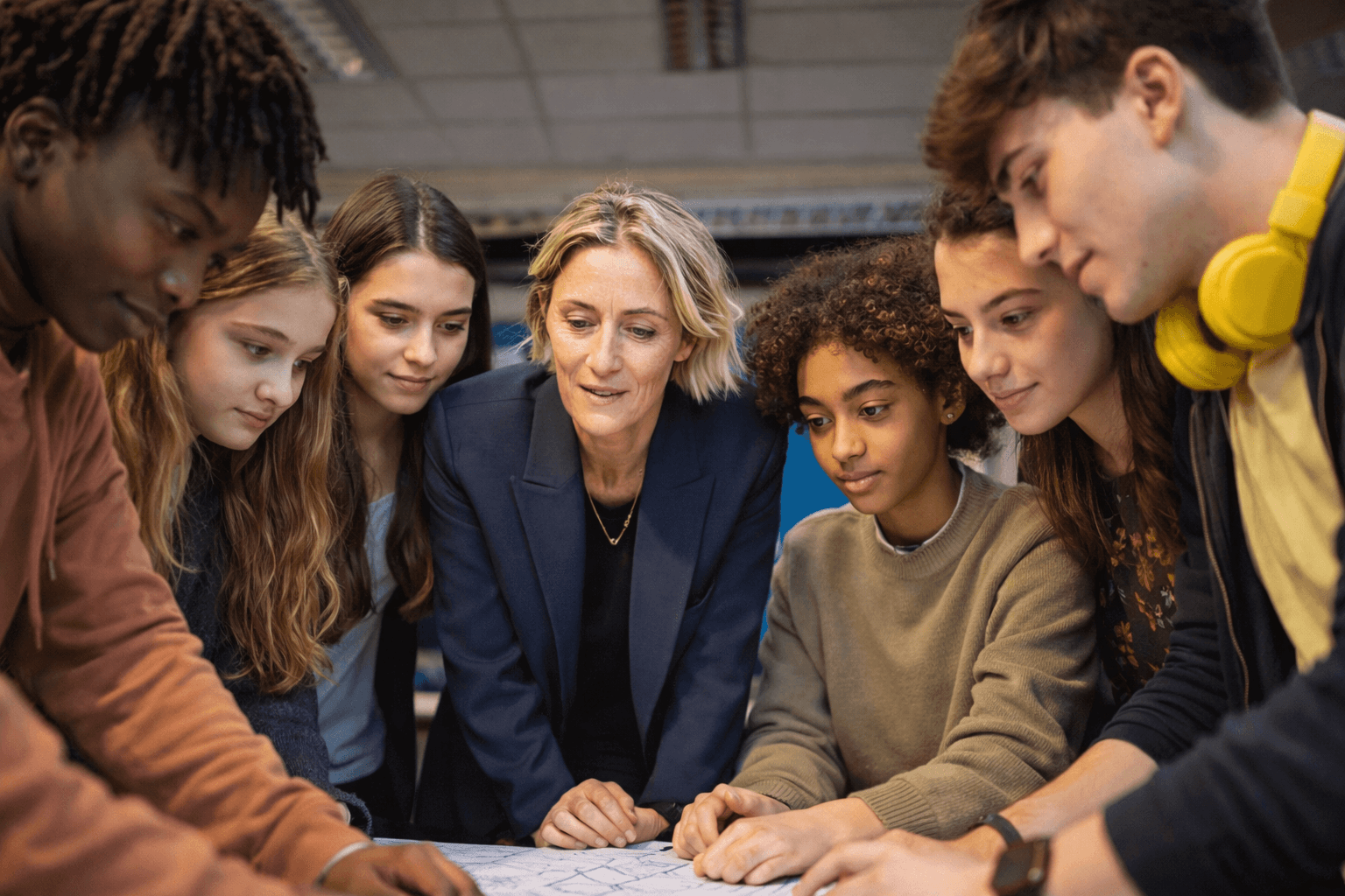 Woman engaging with a group of young people, representing community healthcare connections