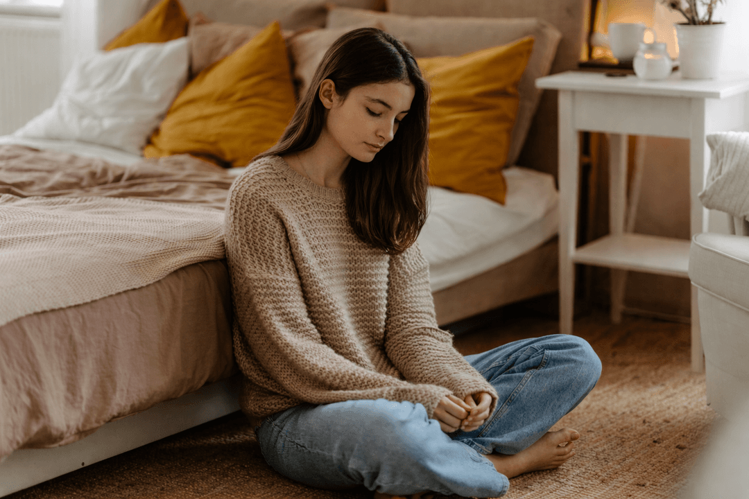 Young person sitting quietly, reflecting